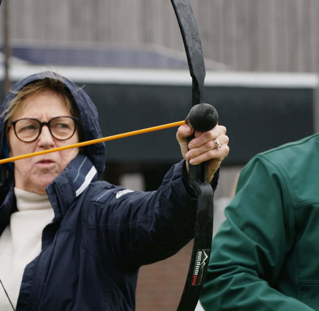 Boogschutter richt op doel tijdens outdoor schutterswedstrijd.